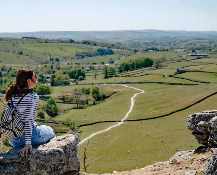 A woman looks out over the Yorkshire Dales