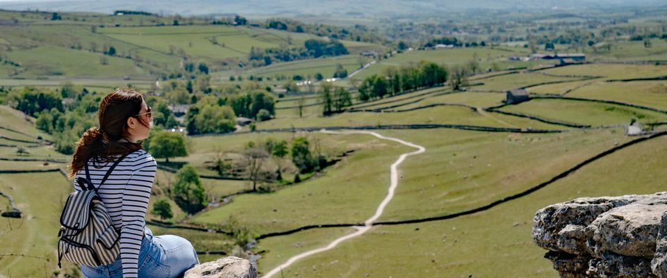 A woman looks out over the Yorkshire Dales